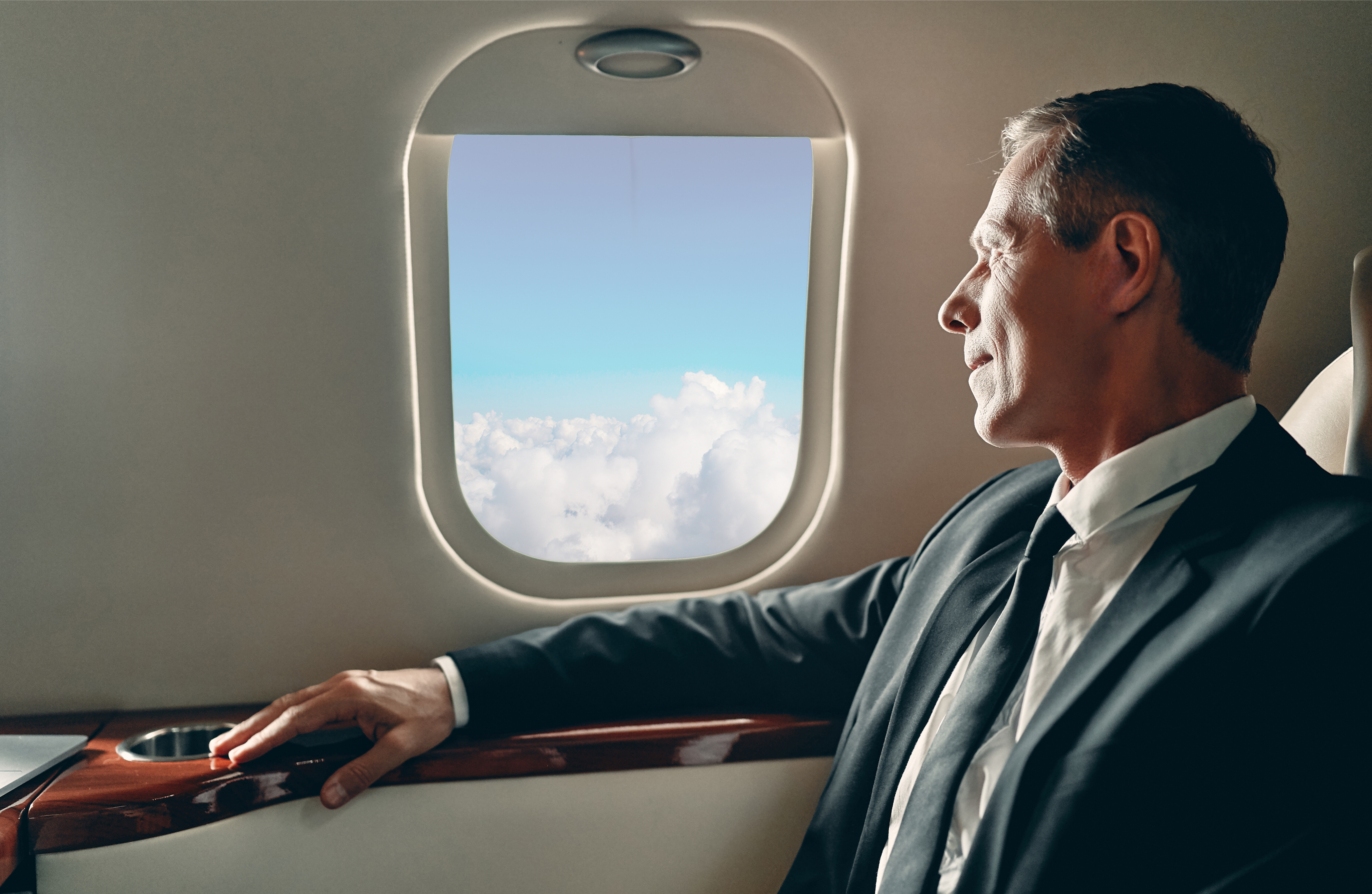 man looking out jet window